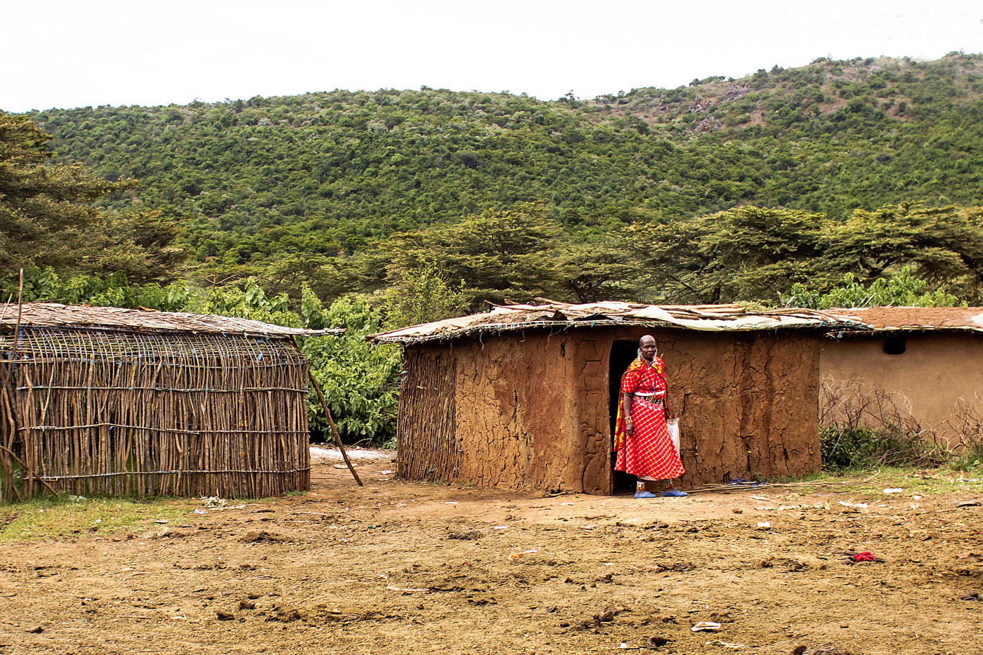 Maasai women in front of a traditional house