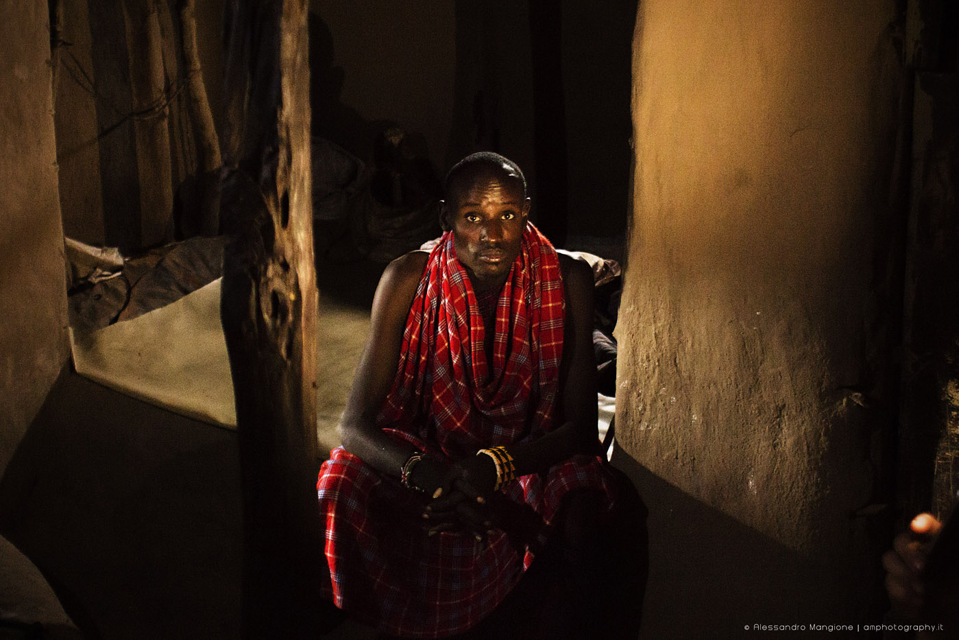 Portrait of maasai tribe man sitting in his mud home